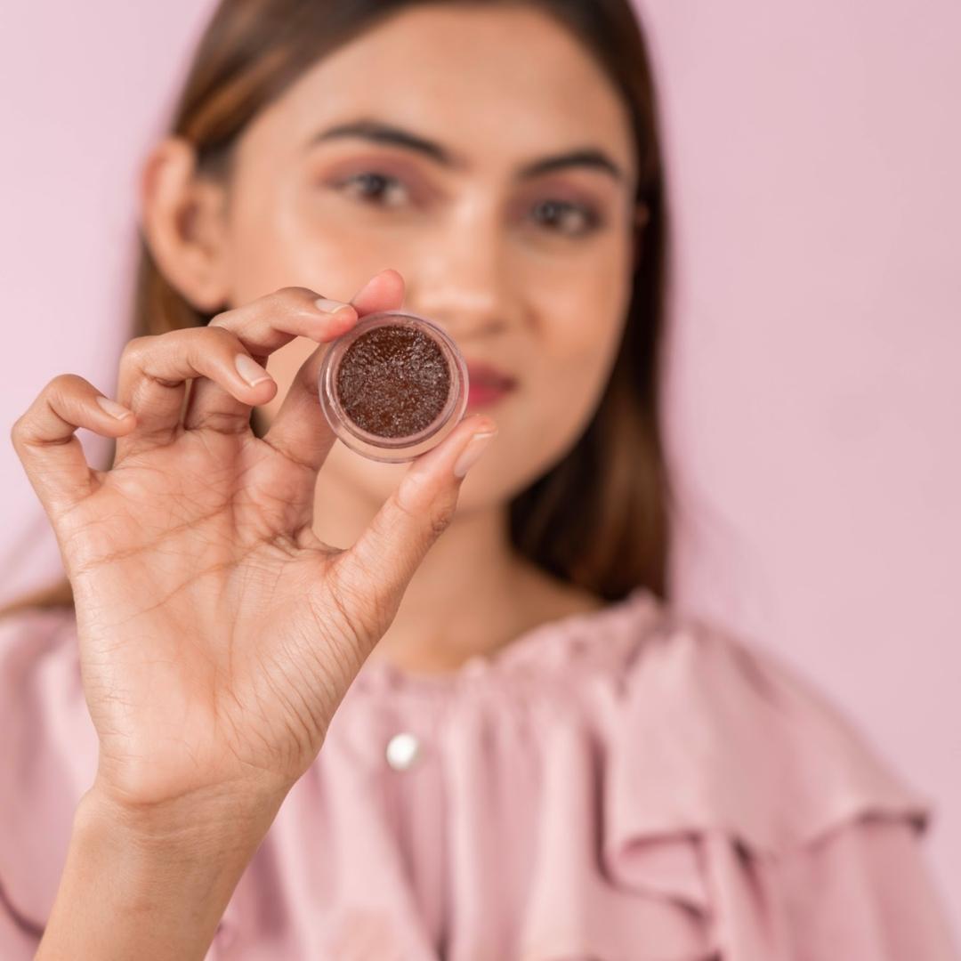 Chocolate Lip Scrub container held by a girl